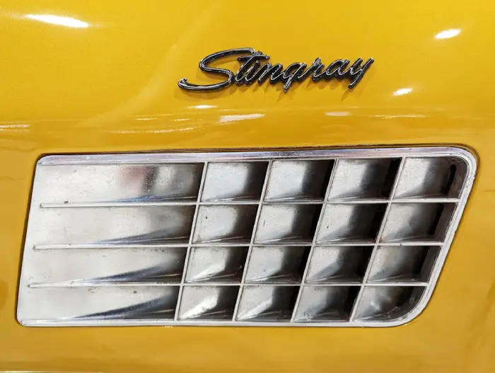 Free Close-up of a yellow Chevrolet Corvette Stingray badge and vent detail. Stock Photo